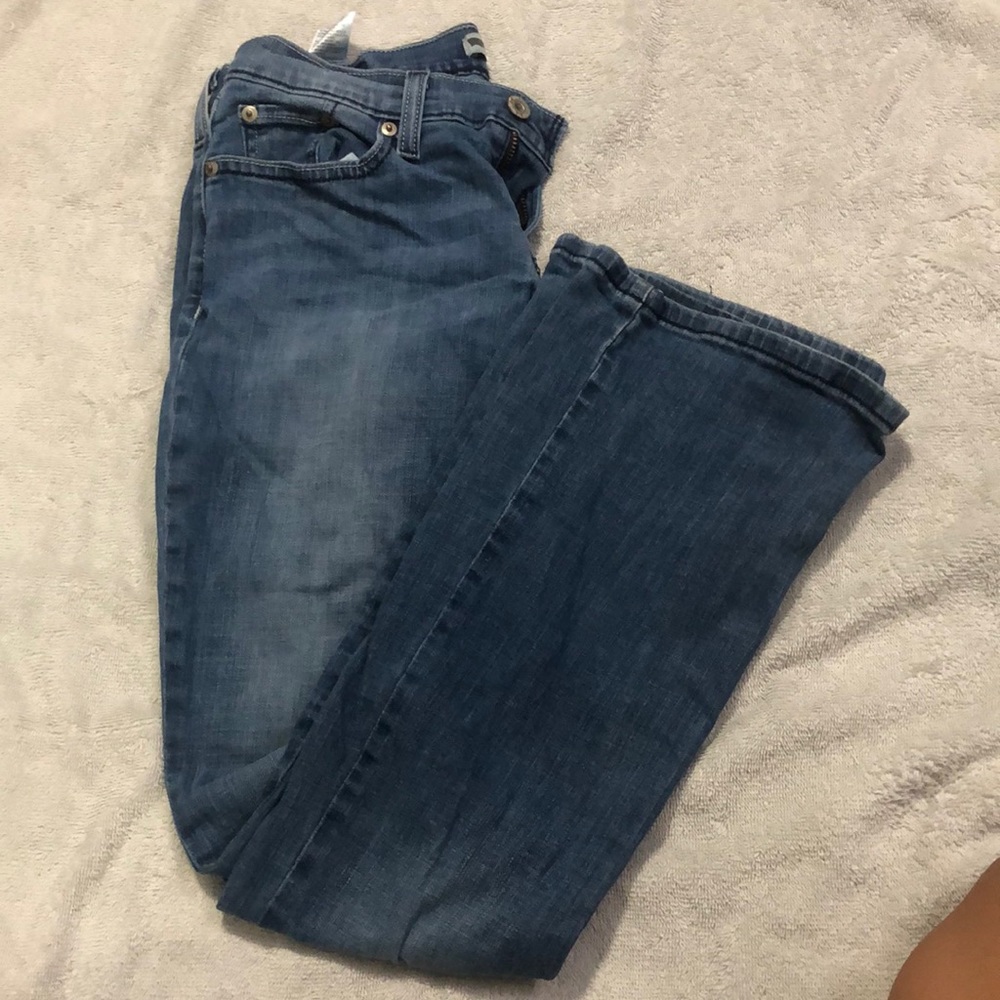 Blue lowrise flaired jeans by Levi,  524 Too Superlow